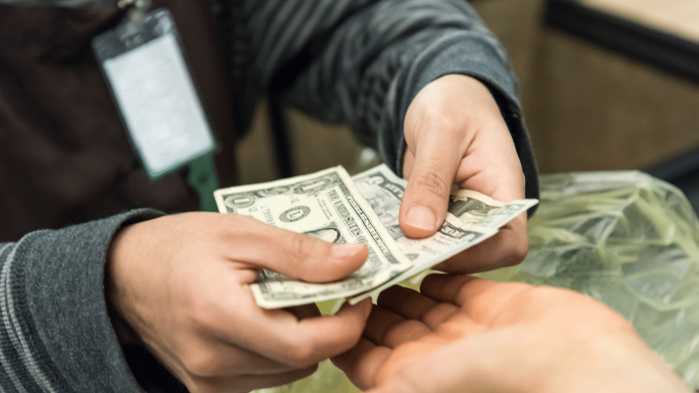 Cash being handed over at a counter